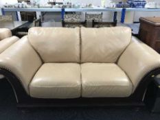 Three seater and two seater leather settees in wood frames
