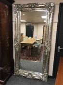 A large silvered rectangular framed mirror