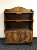 A set of mahogany Reprodux open shelves with cupboard beneath