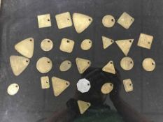 Twenty six miner's lamp checks (tokens or tallies) in a glass display case