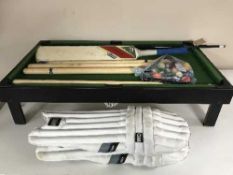 A miniature table top snooker table with accessories and a cricket set