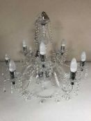 A decorative glass eight branch chandelier with drops