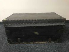 An antique leather bound trunk with metal mounts