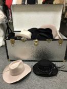 A metal trunk of cow boy hats