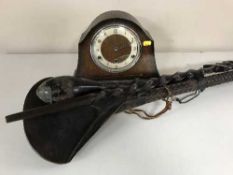 An oak mantel clock, large tribal carved spoon,