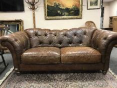 A tan leather Chesterfield over sized settee