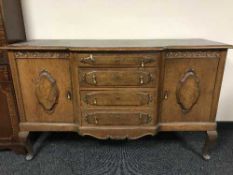An oak break front sideboard
