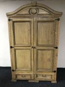 A pine double door wardrobe fitted two drawers