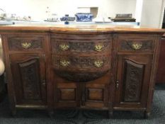 A walnut bow-fronted sideboard