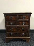 A miniature five drawer chest