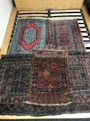 Four fringed woollen rugs