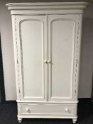 A painted pine double door wardrobe fitted a drawer