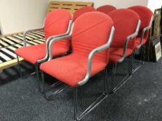 A set of six red upholstered office armchairs
