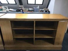 An early 20th century oak double sided library bookcase