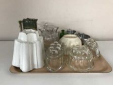 A tray containing vintage glass and pottery jelly molds, Royal Doulton pewter lidded jug,