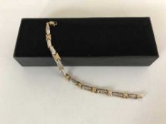 A 9ct yellow and white gold bracelet