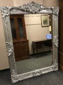 A rectangular silvered ornate framed mirror,