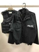 A large quantity of police clothing, badges, caps, black jumpers, white shirts, police work wear,