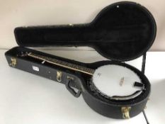 A vintage six-string banjo in Kinsman carry case