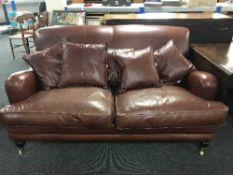 A two seater settee and armchair in maroon leather