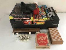 A box of vintage board games, Yamaha recorder, ice skates,