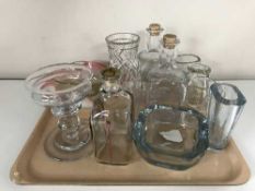 A tray of glass decanters, candle holder, bowls,