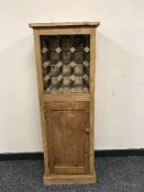 A reclaimed pine bottle rack cabinet