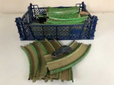 A box of vintage tin plate track and a tin plate car