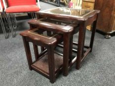 A nest of three mahogany tables