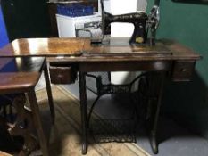 A Singer treadle machine in oak table