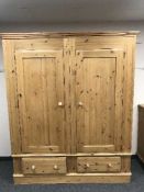 A pine double door wardrobe fitted two drawers