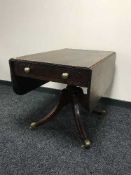 A Victorian mahogany flap sided pedestal table