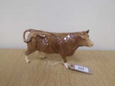 A Beswick figure - Limousin Cow, model 3075B, gloss, with Beswick Collector's Club stamp.
