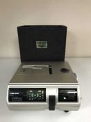 A Braun Paximat Multimag projector in case and a screen