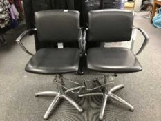 A pair of chrome and leather gas lift armchairs