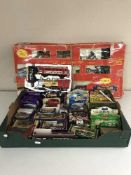 A box of a quantity of boxed die cast vehicles and a Super Express train set with carriages