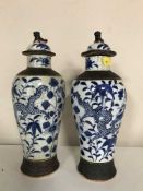 A pair of nineteenth century Chinese blue and white glazed lidded vases with character marks to