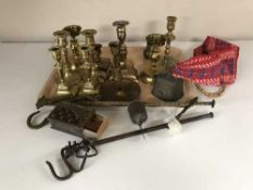 A tray of vintage balance scales, brass candlesticks,