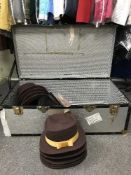 A metal trunk of bowler and gent's hats