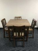 AN oak extending table and four chairs