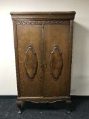 An oak double door serving cabinet