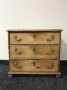 An antique ash three drawer chest