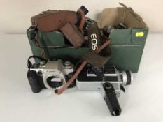 Two boxes of cameras and camera equipment