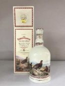 A boxed The Famous Grouse Highland decanter containing Scotch Whisky (70cl) in presentation box,