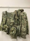 A very large quantity of British Army clothing, jackets, trousers, protective hard hats,