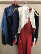 A full rail of coats, outdoor clothing, white overalls,