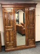 A late Victorian walnut mirror door wardrobe