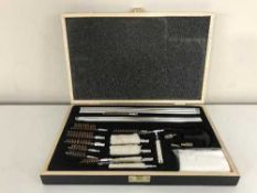 A gun cleaning kit in fitted wooden box