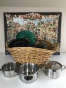 A large wicker basket of china, pans, neck cushion, two prints,