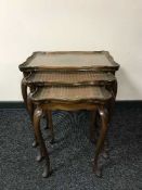 A nest of three walnut tables